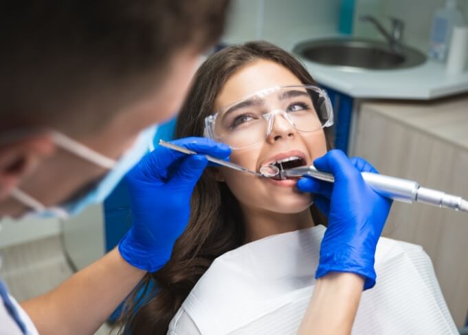 Young woman in dental chair receiving root canal treatment in Orem