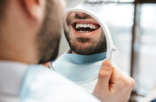 Patient looking at smile in reflection