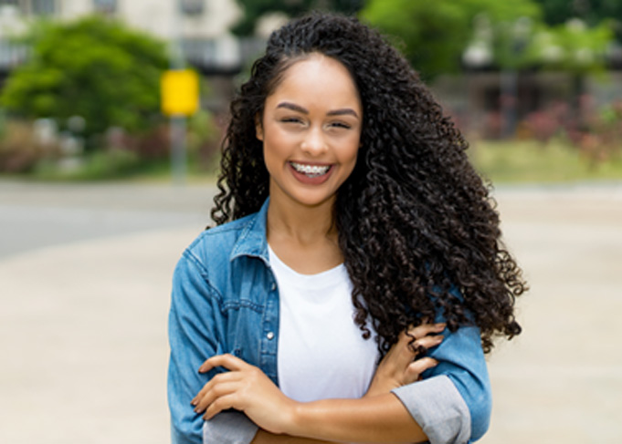 Patient in Orem smiling with traditional metal braces 