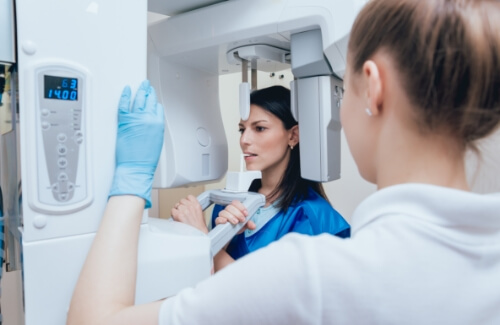 Woman getting a cone beam scan of her jaw in dental office