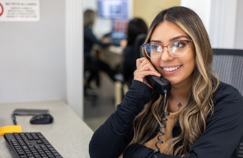 Man smiling at dental office receptionist