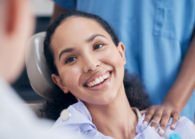 Woman smiling at her dentist after gum disease treatment in Orem