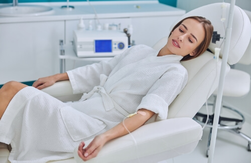 Woman in dental chair with I V hooked up to her arm