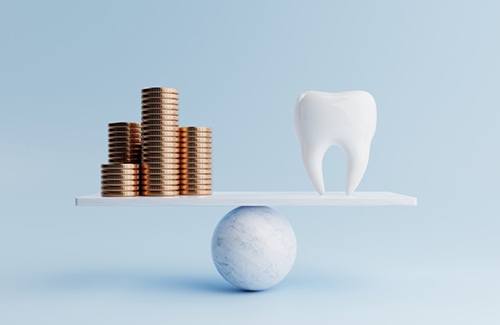 Molar balanced against stacks of coins on scale