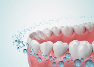 Fluoride bubbles circling teeth.